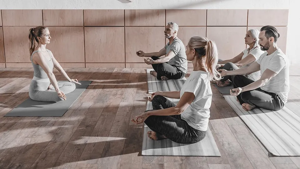 Group yoga session lead by Yoga Instructor